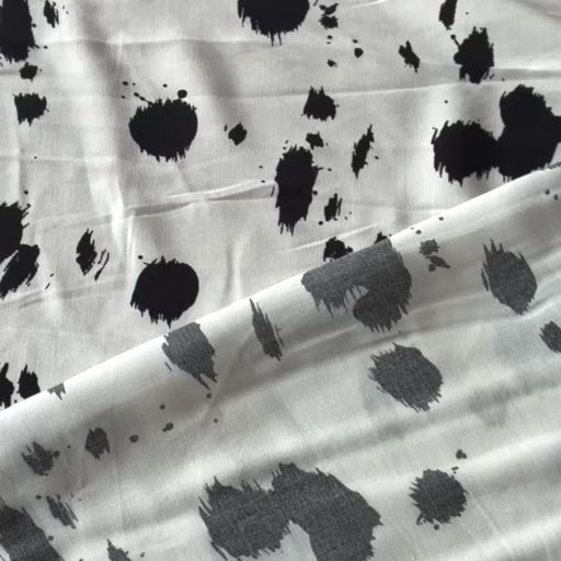 Dalmatian spots viscose dressmaking fabric in a monochrome abstract spotty print