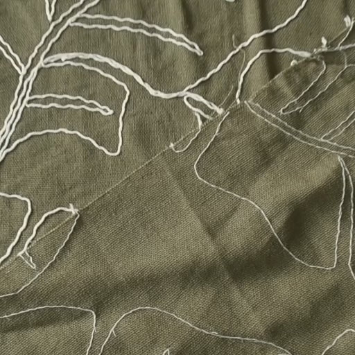 Olive green viscose linen dressmaking fabric with embroidered banana leaf pattern