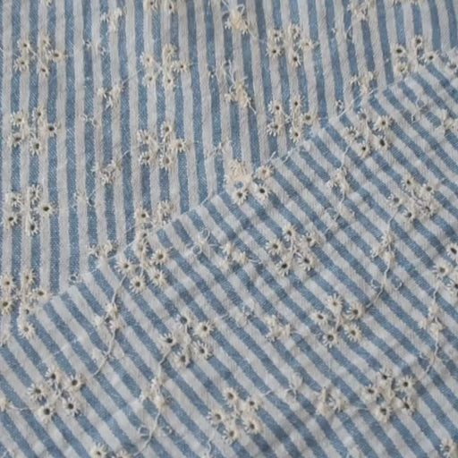 Cotton dressmaking fabric with blue and white design and floral embroidery