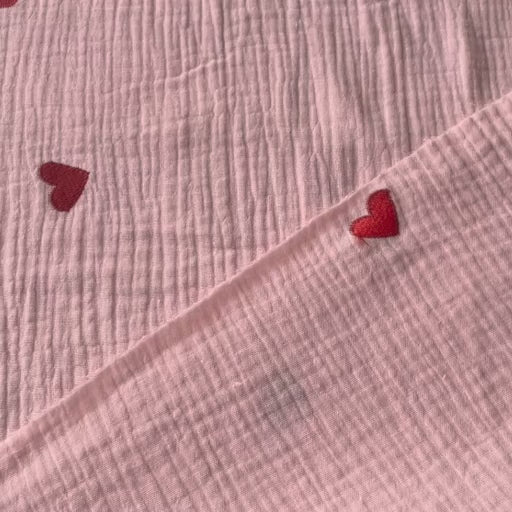 Pink cotton double gauze fabric with embroidered heart pattern for dressmaking
