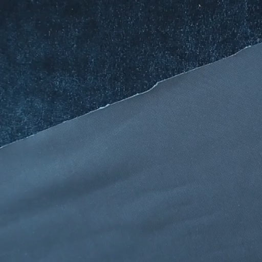 Peacock blue stretch velour fabric with soft sheen for dressmaking.