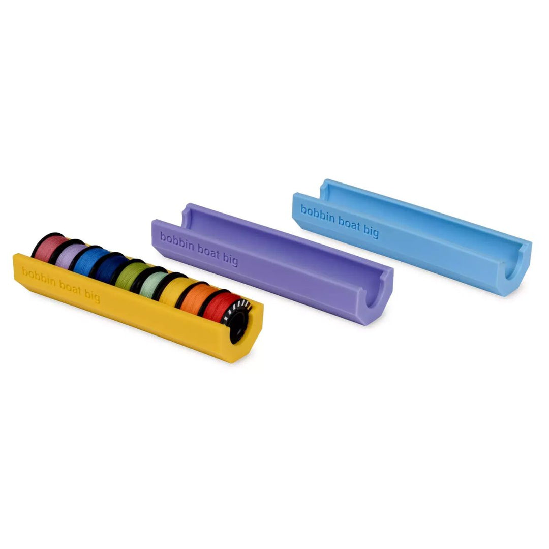 Colorful bobbin holder with colorful bobbins on a white background