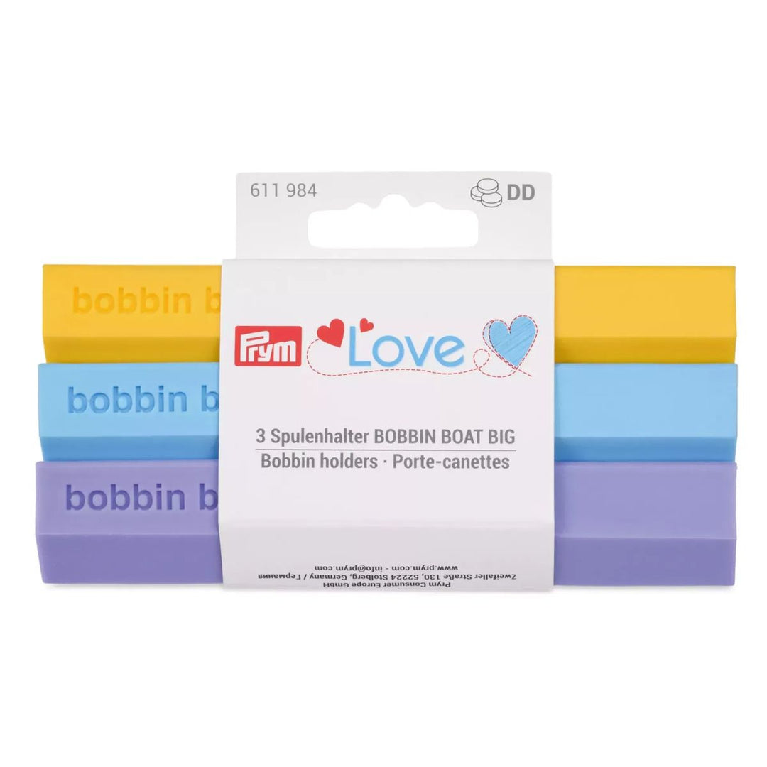 Pack of Prym bobbin holders in yellow, blue, and purple on a white background