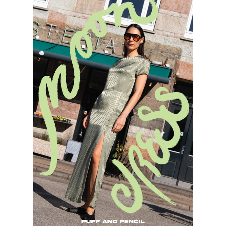 Woman in a green dress standing on a street with text overlay