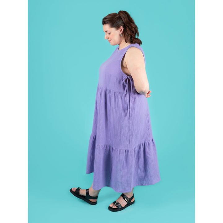 Woman wearing a purple dress against a blue background