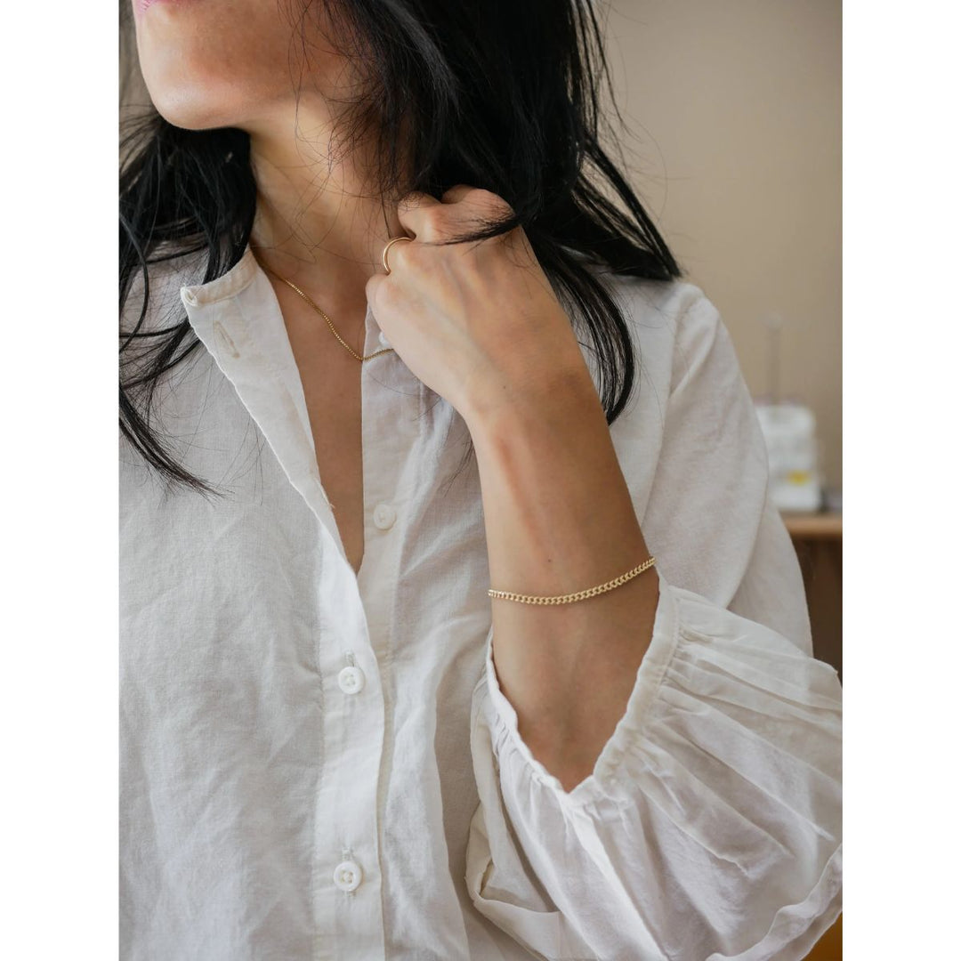 Person wearing a white shirt with a blurred background